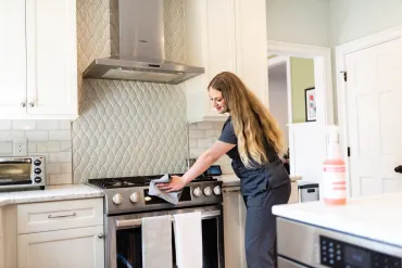 merry maid cleaning a stove